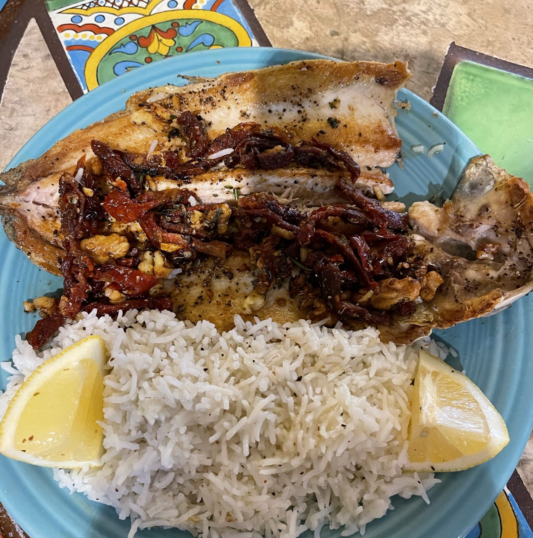 A head and tail on fish prepared to order. Seasoned with an array of flavors to include fennel, lemon, garlic and herbs. Served on a bed of rice.